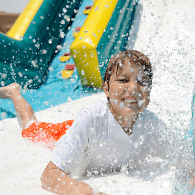 Child laughing while enjoying waterslide rentals in Fort Myers, FL.