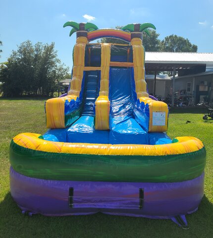 Colorful waterslide with luscious grase and blue skys behind it in Bonita Springs, Florida