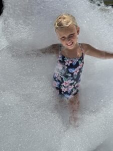 Child playing in a foam party.